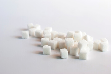 Fototapeta na wymiar A pile of sugar cubes on a white background.