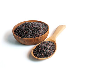 Purple-brown rice in wooden bowl and wooden ladle on white background with clipping path.