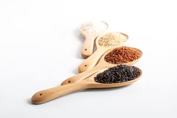 Purple-brown rice, jasmine red rice, jasmine brown rice, jasmine rice in wooden ladle on white background.