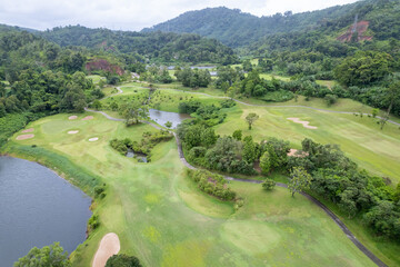 Aerial view drone shot of beautiful green golf field fairway and putting green Top down image for...