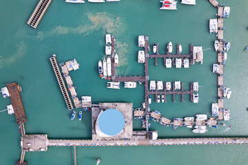 Aerial View Top down Drone shot of Yacht and sailboat parking in marina Transportation and travel background Beautiful sea in summer season