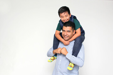 Single dark-haired dad Latino and hispanic son play and have fun together spending quality family...