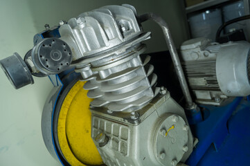 Cylinder head of an old air compressor with an electric motor. Industrial equipment for supplying...