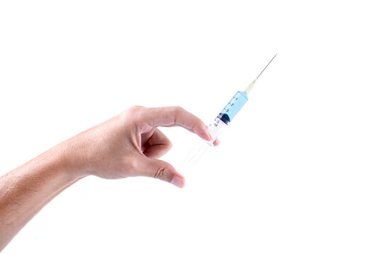 Hand holding syringe with blue serum isolated on white background