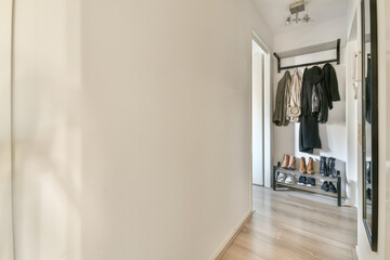 Spacious bright corridor with minimalistic wardrobe and entrance to the bright attic room