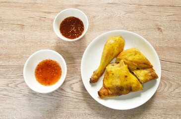 grilled chop chicken on plate dipping with spicy and sweet chili sauce 