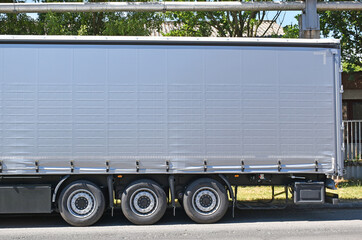 Naklejka na ściany i meble Side view of a large truck on the street