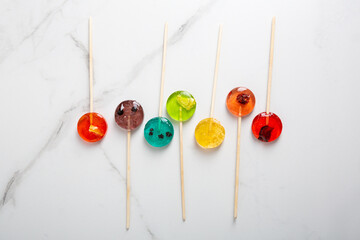 Top view of  mealting homemade fruits candy lollipop