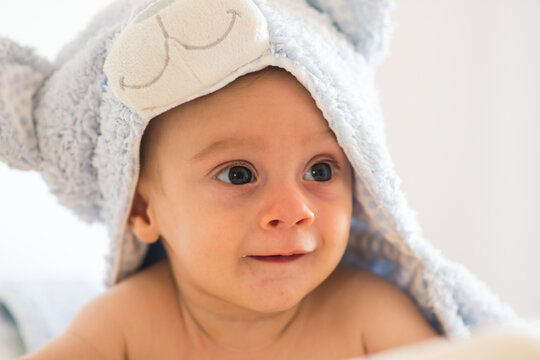 baby with towel on his head