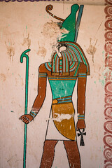 hieroglyph wall painting of horus egyptian god in valley of the kings, luxor egypt holding ankh - obrazy, fototapety, plakaty