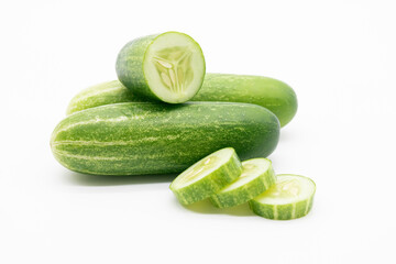 whole cucumber with some pieces isolated on white background.fresh vegetable for salad.