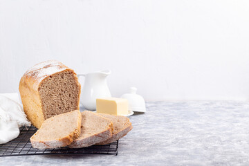 Slices of homemade no knead sandwich bread on cooling rack, horizontal, copy space