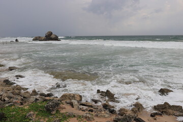 Beautiful sea waves impact rocky coast on the beach