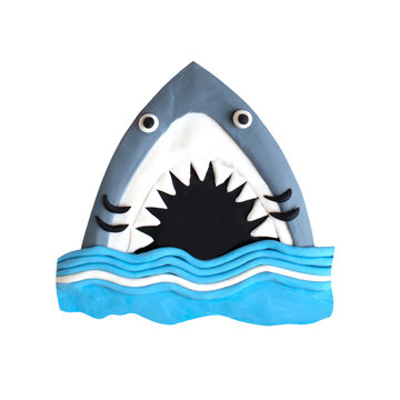 Wild cute underwater marine fish cartoon childish handmade craft shark with a opened mouth with sharp teeth in a water ocean wave figure modeling sculpture. Jaw teeth.