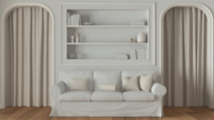 Blurred background, neoclassic living room close up, molded walls with bookshelf. Arched doors with curtains and parquet floor. Modern sofa and carpet. Classic interior design