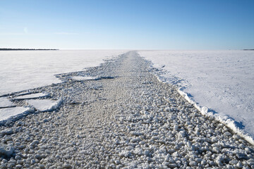 Fototapeta na wymiar A Trail of Broken Ice on the Frozen Baltic Sea