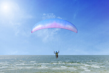 Paraglider in the blue sky on a sunny day