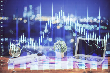 Forex graph hologram on table with computer background. Double exposure. Concept of financial markets.