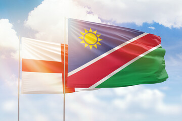 Sunny blue sky and flags of namibia and england
