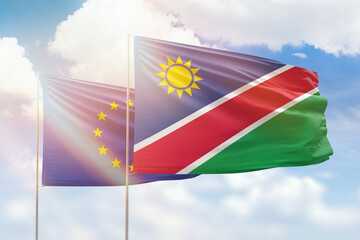 Sunny blue sky and flags of namibia and european union