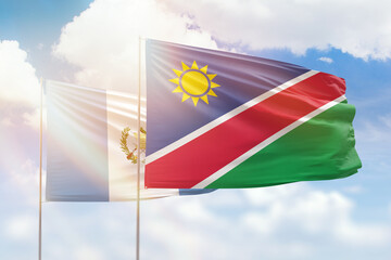 Sunny blue sky and flags of namibia and guatemala