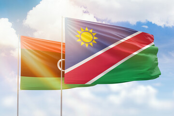 Sunny blue sky and flags of namibia and libya