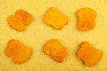image of chicken nuggets gold background 