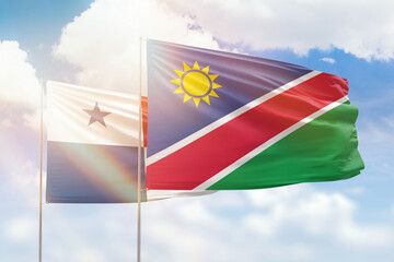 Sunny blue sky and flags of namibia and panama