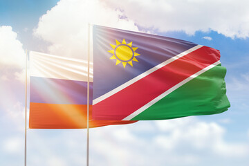 Sunny blue sky and flags of namibia and russia