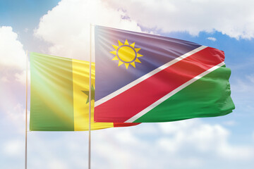 Sunny blue sky and flags of namibia and senegal