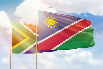 Sunny blue sky and flags of namibia and south africa