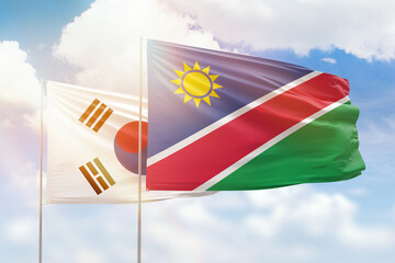 Sunny blue sky and flags of namibia and south korea