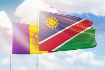 Sunny blue sky and flags of namibia and andorra