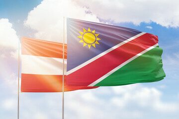 Sunny blue sky and flags of namibia and austria