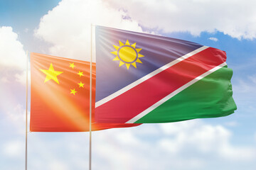 Sunny blue sky and flags of namibia and china
