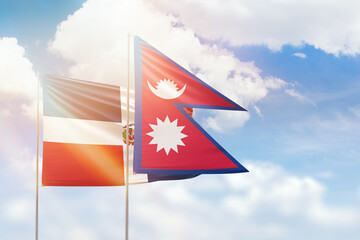 Sunny blue sky and flags of nepal and dominican republic