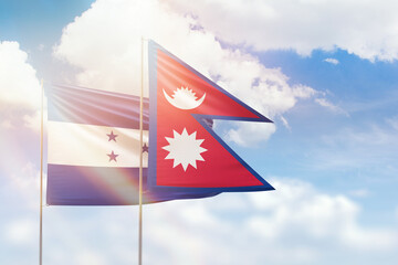 Sunny blue sky and flags of nepal and honduras