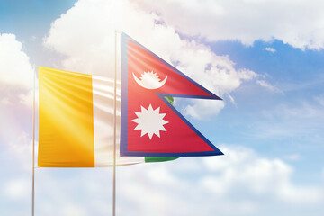 Sunny blue sky and flags of nepal and ivory coast