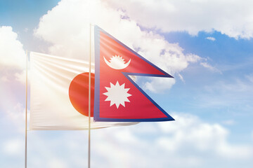 Sunny blue sky and flags of nepal and japan