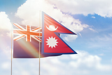Sunny blue sky and flags of nepal and new zealand