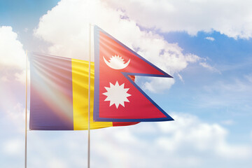 Sunny blue sky and flags of nepal and romania