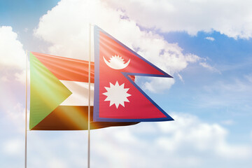 Sunny blue sky and flags of nepal and sudan