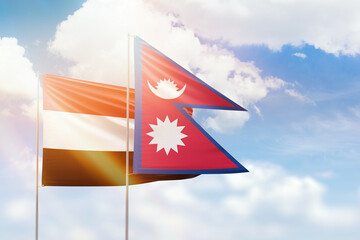 Sunny blue sky and flags of nepal and yemen