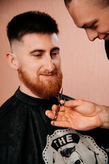 Haircut red beard with scissors
