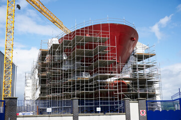 Shipbuilding and crane during ferry construction surrounded by scaffold