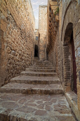 Fototapeta na wymiar Walking along the old narrow streets smelling of history/Mardin,Turkey