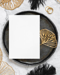 Black and golden wedding table setting with a blank card top view, mockup