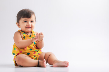 Cute indian baby girl smiling and giving expression.