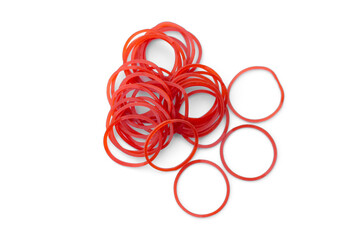 Elastic red rubber bands on white background. Concept : A versatile rubber band for tying things, bags or hair, can be reuse for many times. - obrazy, fototapety, plakaty