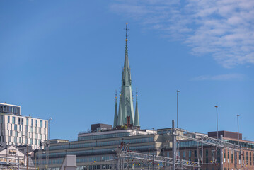 The spire of the down town church Klara Kyrka, hotel and office buildings a sunny summer day in...